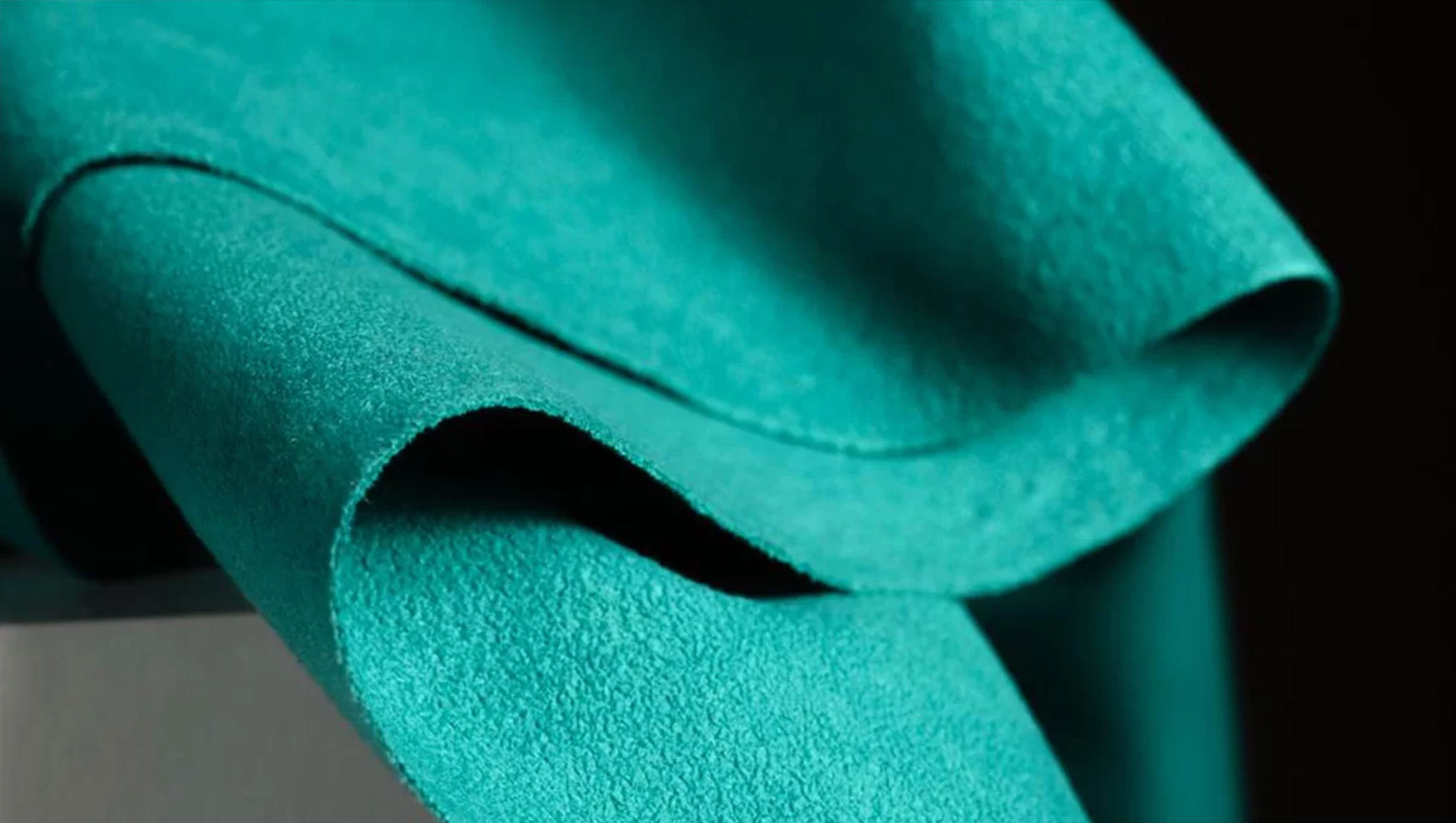 Close-up image of a Sage suede